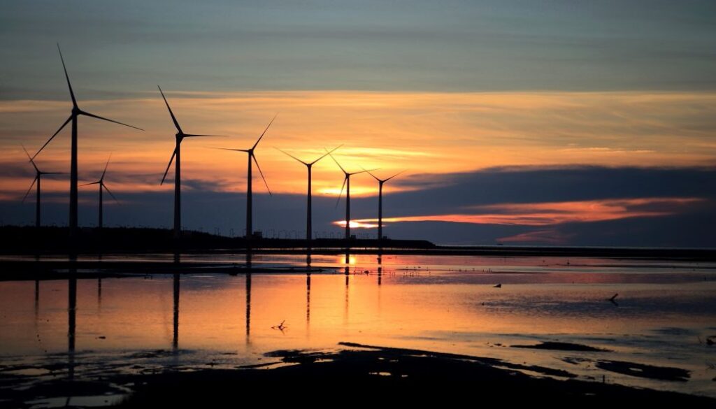 wind turbines farm beach sunset